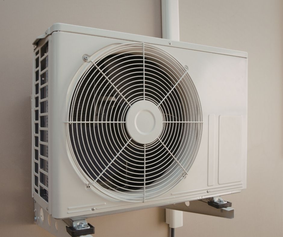mini split outdoor unit on a white wall